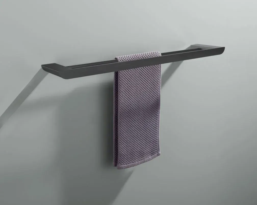 Matte black towel rail holding a mauve hand towel on a grey wall
